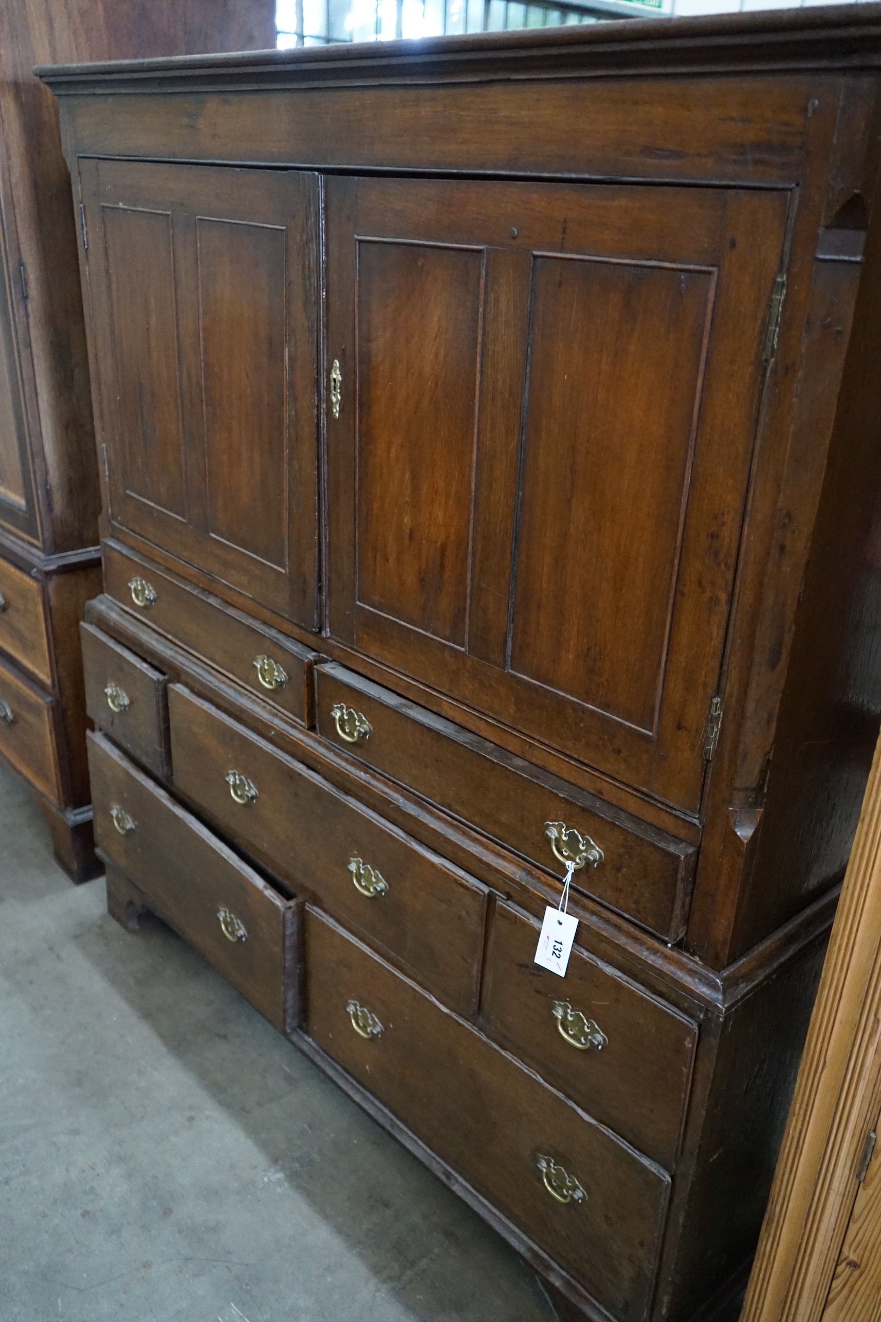 An 18th century oak two section press cupboard, width 127cm, depth 51cm, height 143cm
